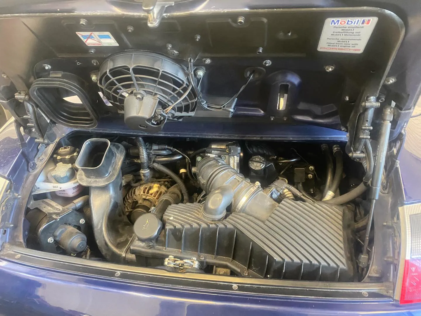 The engine bay of a Porsche Boxster in the Attwood Motors workshop