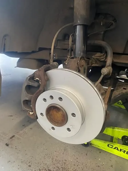 A new front brake disc on a Mercedes Sprinter camper, the wheel off, in the Attwood Motors workshop